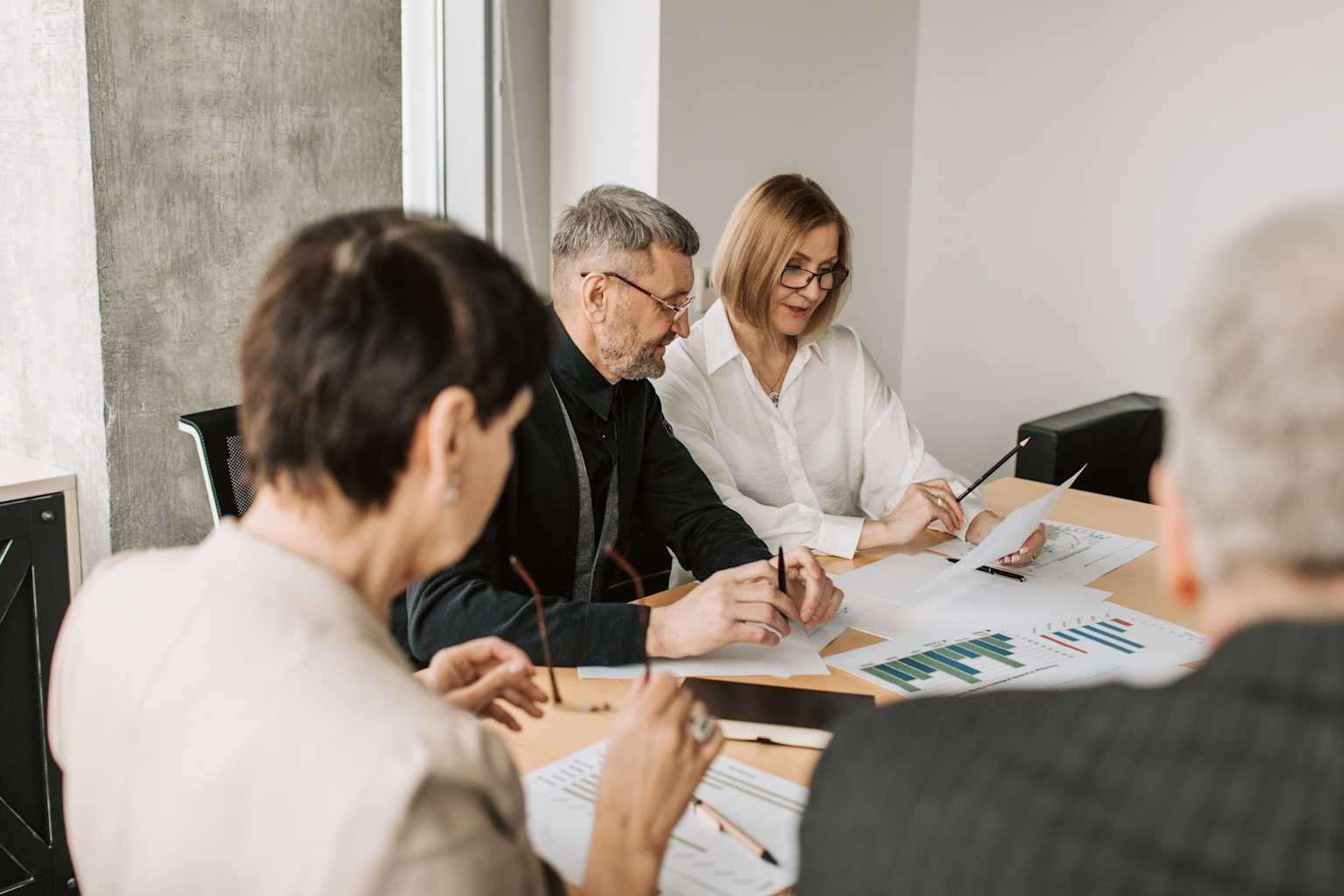 Business professionals reviewing financial and commercial materials