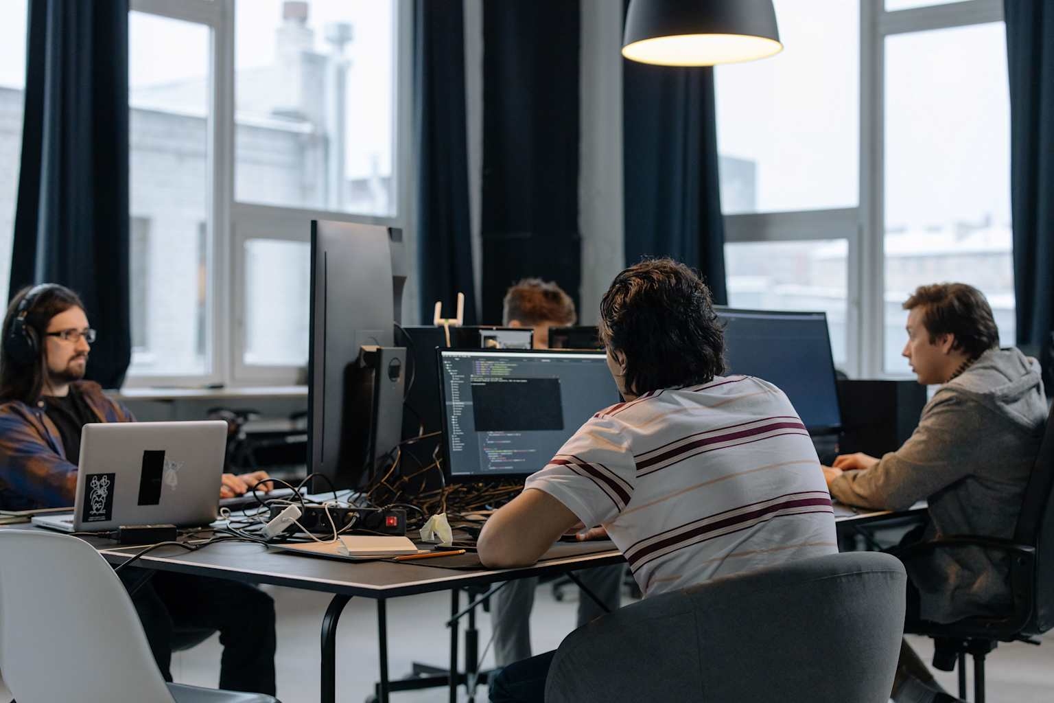 Technology team collaborating at computer workstations
